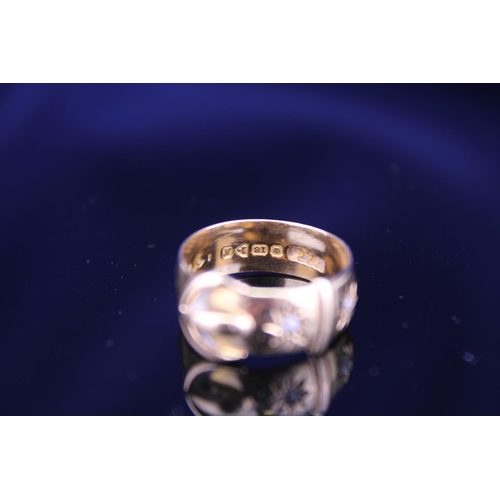 220 - An 18ct Gold Buckle Ring set with two small Diamonds. Total weight approximately: 5.9grams. Size app... 