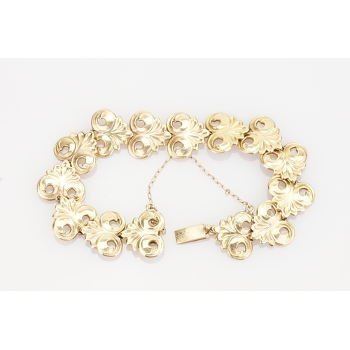 221 - A 9ct Gold Bracelet in the Gesso design with safety chain. Weight approximately: 18.3 grams.