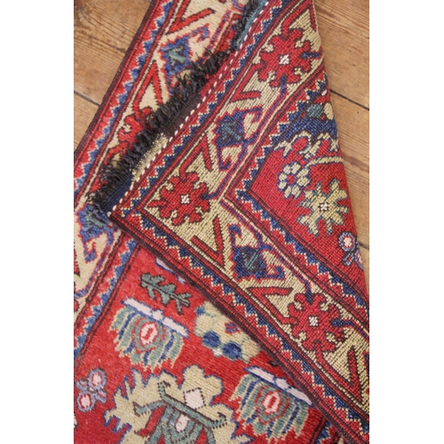 397 - A Rust & Beige bordered Blue Central Medallioned Geometric Weaved Runner. Measuring: 200cms long x 6... 