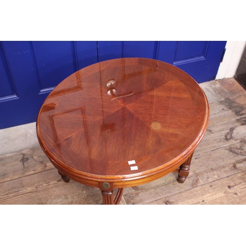 620 - An Oval Coffee Table with a lacquered top and carved legs. Measuring: 53cms high x 65cms x 57cms.