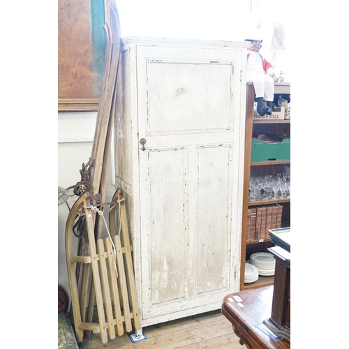 392 - A White Painted Single Door Wardrobe with fitted shelves. Measuring: 75cms across x 40cms deep x 173... 