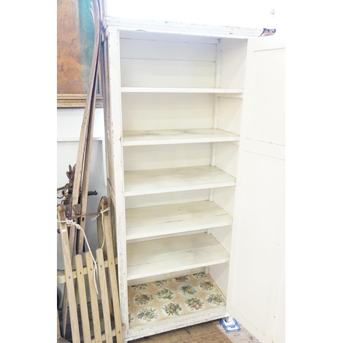 392 - A White Painted Single Door Wardrobe with fitted shelves. Measuring: 75cms across x 40cms deep x 173... 