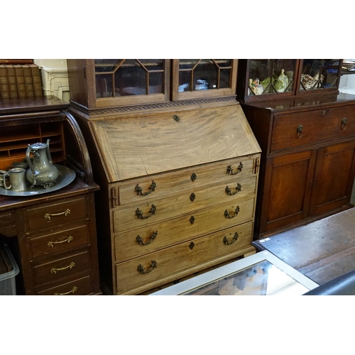 394 - A Georgian Mahogany Bureau fitted with Four Graduated Drawers, Brush & Slides, Swept Bow Feet, Brass... 