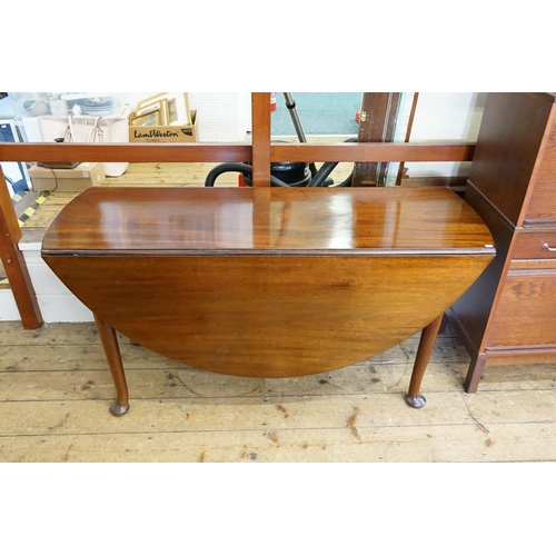 406 - A George II Mahogany Drop-Flap Circular Top Dining Table resting on Pad Feet. Measuring: 144cms long... 