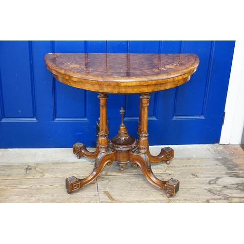 409 - A Victorian Demi-Lune Walnut veneered Fold Over Top Card Table resting on quadruple turned supports ... 