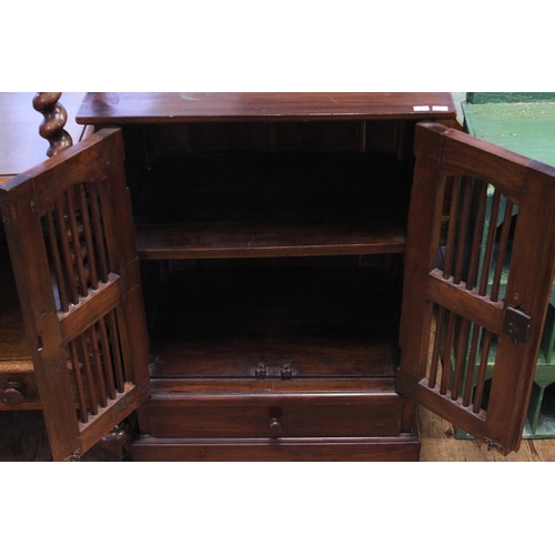 488 - An Indian hardwood splat door cabinet fitted with double doors & resting on a square base. Measuring... 