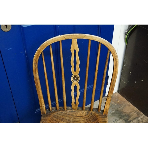 502 - An Antique Elm Seated Turned & Pierced Back Windsor Chair resting on a Crinoline Base & a Turned Bas... 