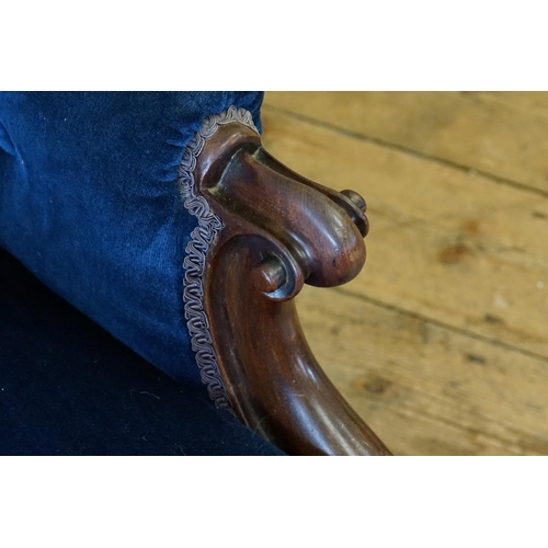 520 - A Victorian Mahogany Framed Button Backed Easy Chair resting on Chamfered Legs.