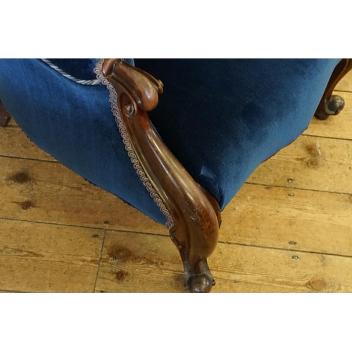 520 - A Victorian Mahogany Framed Button Backed Easy Chair resting on Chamfered Legs.