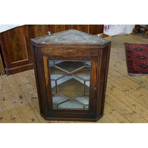 523 - A Georgian Oak Astragal Glazed Single Doored Corner Cabinet fitted with shelves. Measuring: 70cms ac... 