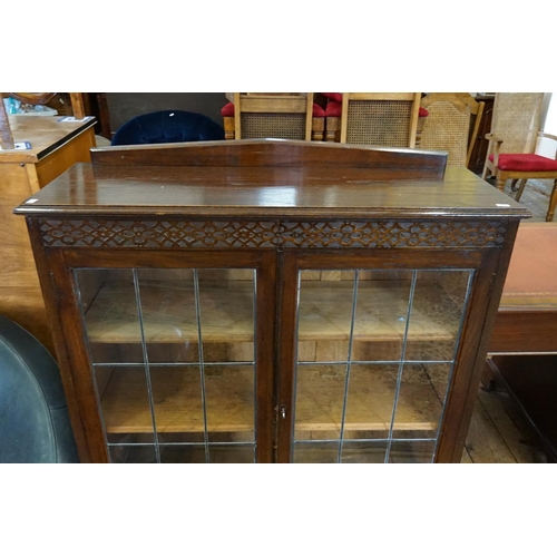 553 - A 1920s Oak Leaded Door Display Cabinet resting on a Cross Stretcher & turned Bobbin Legs. Measuring... 