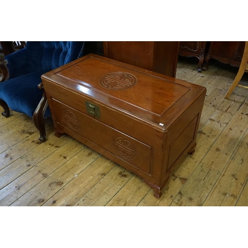 561 - A Chinese Hardwood Coffer with traditional decoration resting on square feet. Measuring: 100cms acro... 