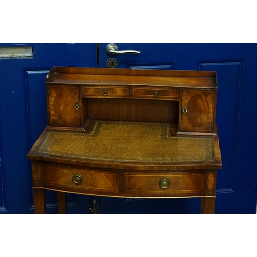 594 - A Reproduction Cheriton writing desk fitted with two cupboards, inset leather top, resting on square... 