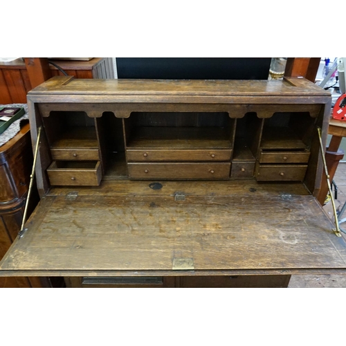 597 - An Art Nouveau Bureau fitted with a Leaded Glazed Door, one long drawer above two short drawers & re... 