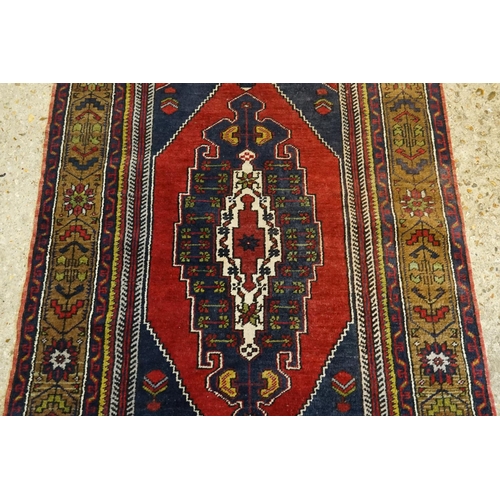 266 - A Red & Blue Ground Geometric Central Medallion Saw Tooth Bordered & Olive Green Ground Floral decor... 