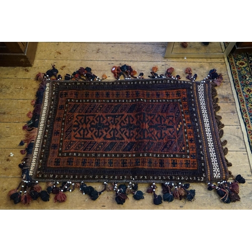 268 - A Persian Design Rust, Brown & Red Ground Beige edged Saddle Bag hung with Tassels. Measuring: 110cm... 