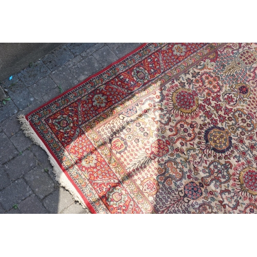 271 - A large Persian Design All Over & Red Bordered Carpet with a fringed edge. Measuring: 390cms long x ... 