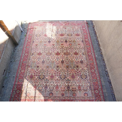 271 - A large Persian Design All Over & Red Bordered Carpet with a fringed edge. Measuring: 390cms long x ... 