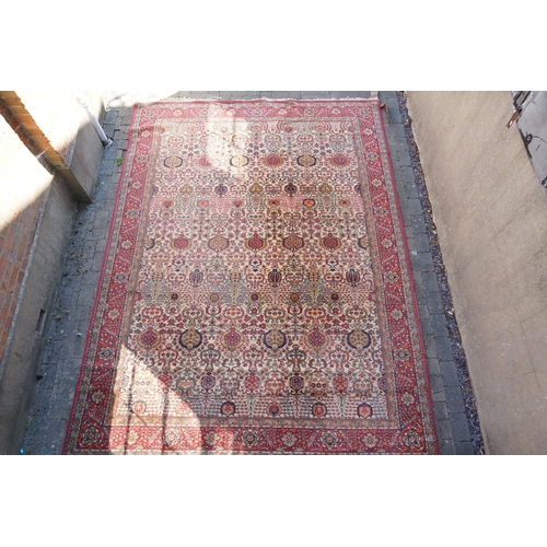 271 - A large Persian Design All Over & Red Bordered Carpet with a fringed edge. Measuring: 390cms long x ... 