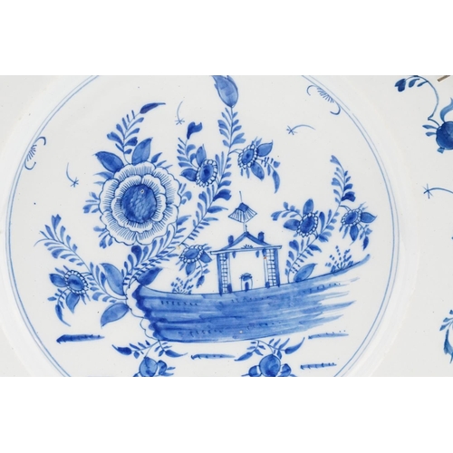 839 - An Antique English Delft Ware Charger decorated with Flowers in a Garden scene. Measuring: 35cms.