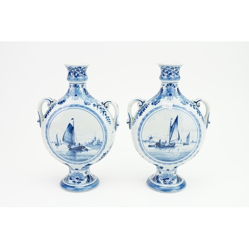 851 - A Pair of Bottle Shaped Delft Ware Vases marked H & G, decorated with boats on a canal with windmill... 