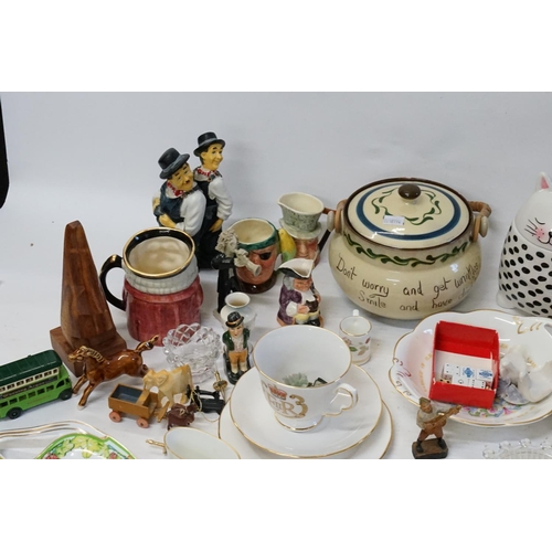 856 - A Devon Motto Ware Biscuit Barrel decorated with a Cottage, Toby Jugs, Mugs, Slippers, Paperwork, et... 