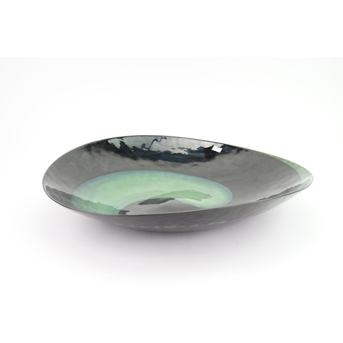 308 - A modern Murano green and black glass bowl with a fixed paper sticker. Measuring: 46cms Diameter.