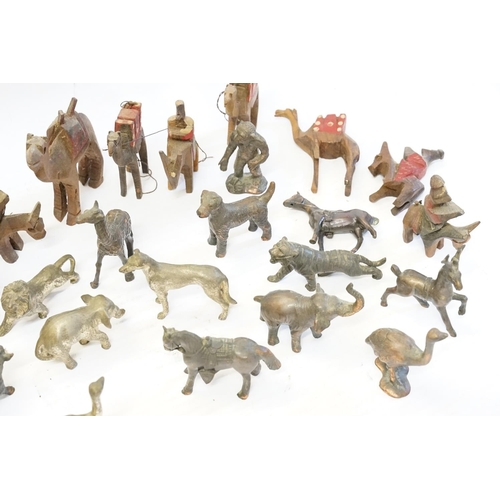 407 - A collection of bronzed animals and antimony  and a collection of Egyptian carved wood camels.