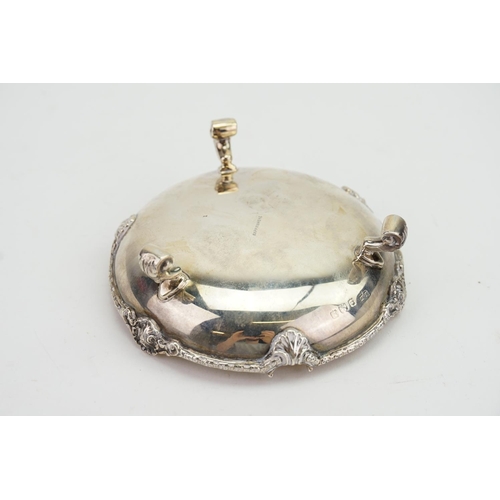 22 - A Silver Cast edged Pin Dish resting on floral swag feet. Weighing: 119 grams.