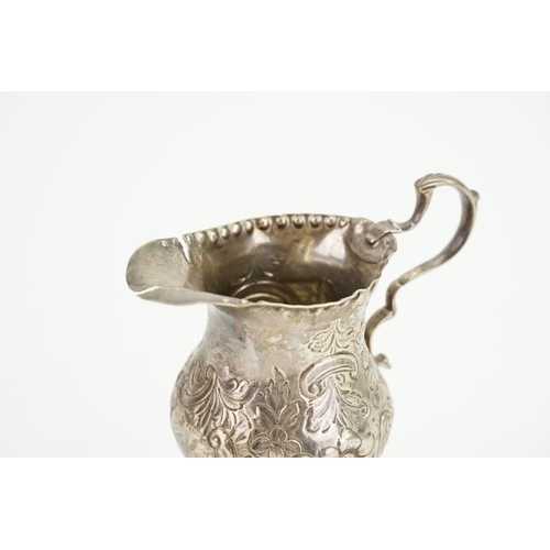 37 - A Georgian Silver Cream Jug with embossed decoration. (AF). Weighing: 60 grams.