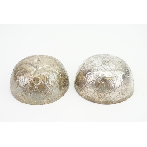 42 - A Pair of Indian Embossed Silver Coloured White Metal Offering Bowls with floral decoration.