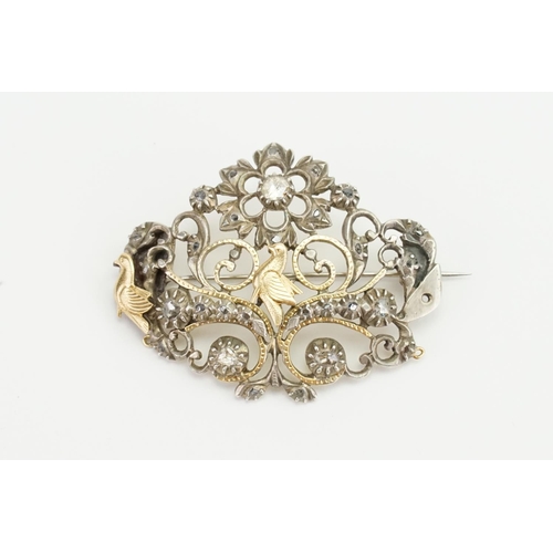 86 - An Indian Silver Diamond Set & Gold Mounted Brooch designed with Birds, Floral Scrolls, etc.