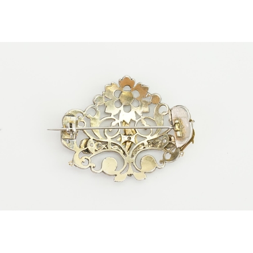 86 - An Indian Silver Diamond Set & Gold Mounted Brooch designed with Birds, Floral Scrolls, etc.