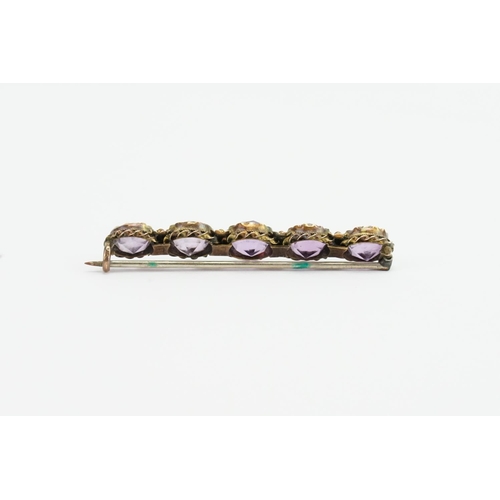 95 - A Ladies 12ct Gold Amethyst Brooch mounted in a Filigree Style Mount.