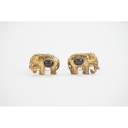 140 - A pair of Indian 18K Gold cufflinks designed as elephants set with star stones. Weighing: 8.2 grams.