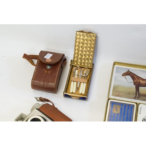 744 - A 1920s/30s blue enamelled compact with necessaire, opera glasses and packs of playing cards, a glas... 