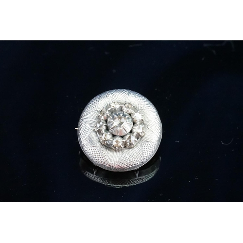 148 - An interesting diamond set cluster brooch, set with 9 small diamonds, approximately 0.10ct. One larg... 