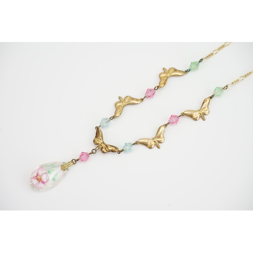 149 - A 9ct Gold floral glass beaded necklace. Decorated with flowers and butterflies. Weight approximatel... 