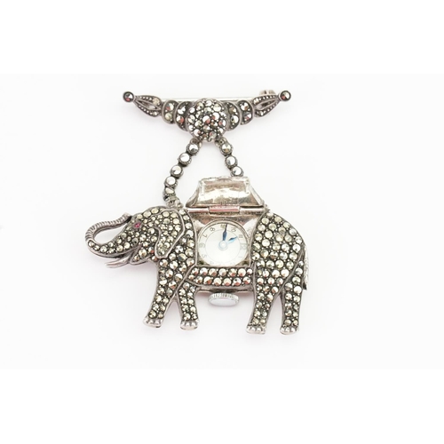 150 - A Silver marquisate elephant brooch, set with a clock inside.