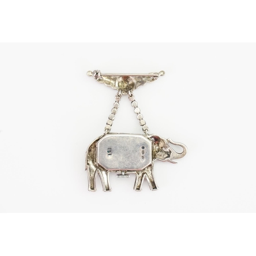 150 - A Silver marquisate elephant brooch, set with a clock inside.