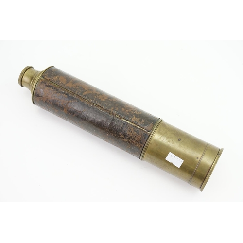 702 - A late 19th century brass cased telescope with leather cover.