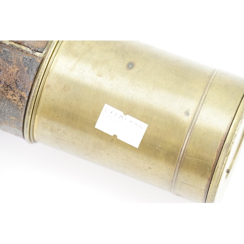 702 - A late 19th century brass cased telescope with leather cover.