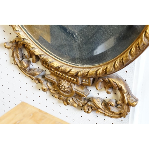 604 - A Lovely gilt framed oval mirror. Measuring: 47cms across x 90cms high.