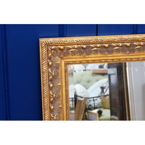 609 - A large gilt framed, bevelled glass wall mirror. Measuring: 69cms W x 79cms D.