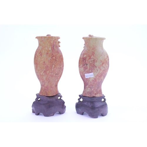 435 - A Pair of Chinese Red Fleck Soap Stone Vases decorated with Floral & Leaf Festoons. Height: 22cms.