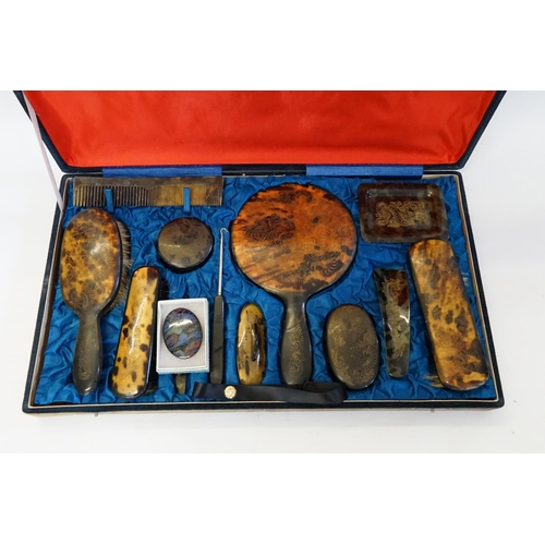 444 - A Chinese Tortoise Shell effect Dressing Table Set in a Fitted Case decorated in Gold Highlights.