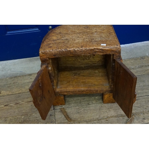 740 - A Treasures Box carved from a single lump of hardwood fitted with peg and spade hinges and standing ... 