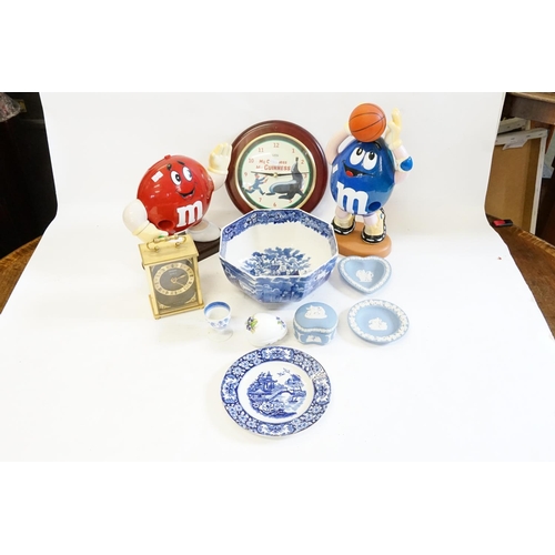 294 - Two M. & M. plastic sweet dispensers together with two clocks, one Guinness and various blue and whi... 