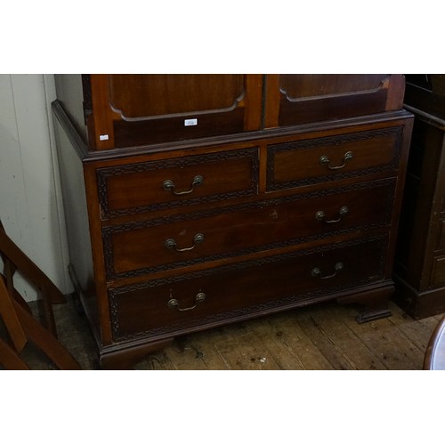 556 - An Edwardian Mahogany Linen Press with Blind Fret Carving, Swan Neck Handles & Fitted Shelves. Measu... 