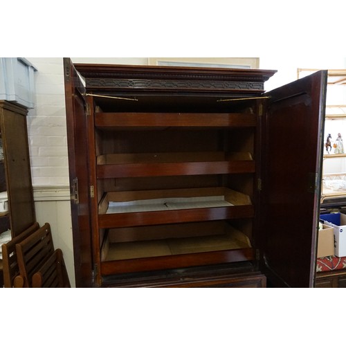 556 - An Edwardian Mahogany Linen Press with Blind Fret Carving, Swan Neck Handles & Fitted Shelves. Measu... 